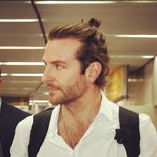 Bradley Cooper's bun is tiny but well placed.